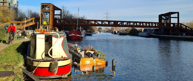 Your narrowboat sinks! Will insurance cover it? 7 boats in a river with a bridge over it